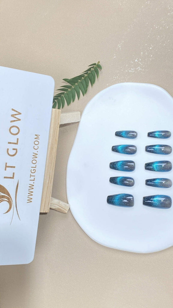 LTGlow handmade press-on nails in coffin shape with black and blue cat eyes design and glitter accents