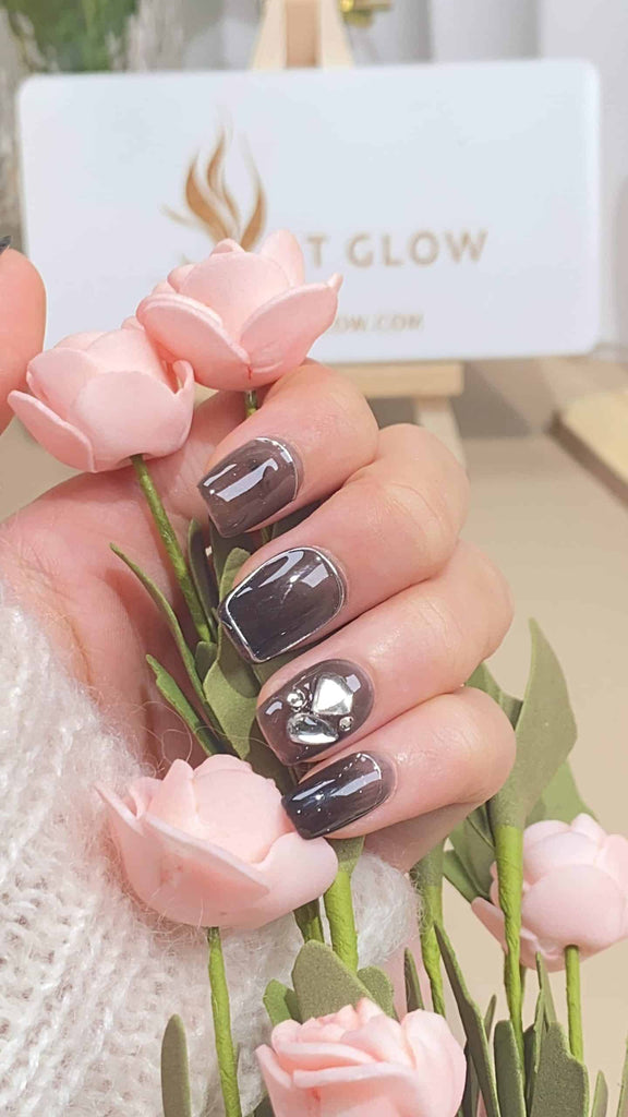 Handmade squoval press-on nails by LTGlow, featuring a classic black base, adorned with sparkling diamonds and shimmering glitter for a luxurious look