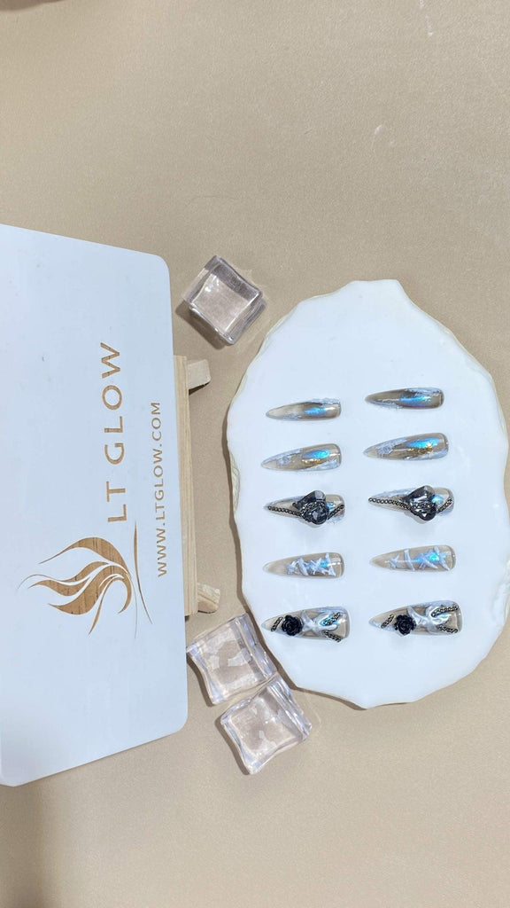 Stiletto-styled fake nails from LTGlow, capturing a harmonious mix of black and gray, enhanced by delicate rose designs and intricate charms