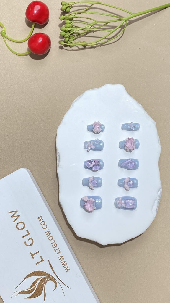 Coffin-shaped fake nails from LT-Glow in a captivating blue shade, featuring diamond embellishments, whimsical hearts, and wing designs for added elegance