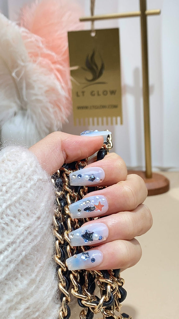 Handcrafted coffin press-on nails by LTGlow, showcasing a deep blue hue adorned with lustrous pearls, twinkling stars, and radiant diamonds for a celestial touch