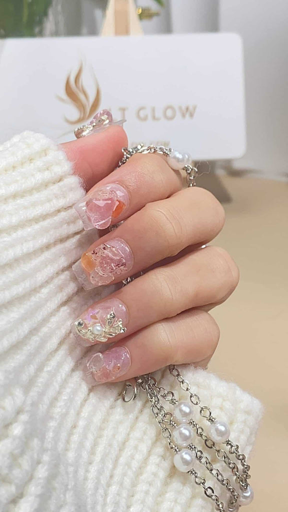Discover the elegance of coffin-shaped press on nails, adorned with shimmering glitter, diamonds, crystals, and pearls. An epitome of luxe artificial nails design handcrafted for the modern woman