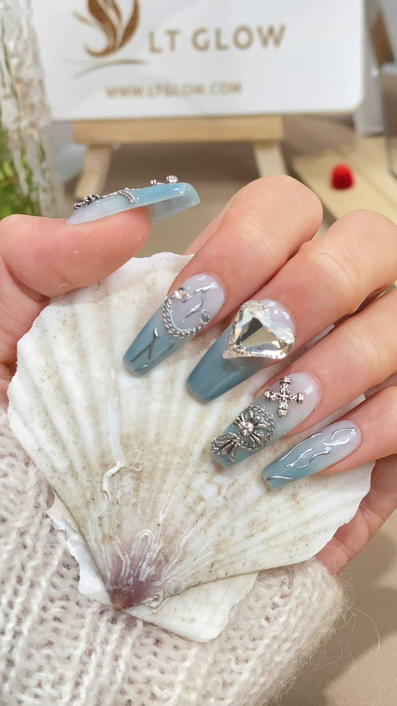 Dive into the mesmerizing depth of our gradient blue coffin-shaped press-on nails, adorned with delicate heart charms for a romantic touch
