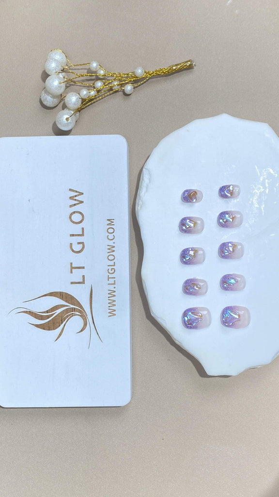 Round-shaped fake nails from LTGlow, adorned with a mesmerizing gradient of purple, complemented by shimmering crystals and glitter