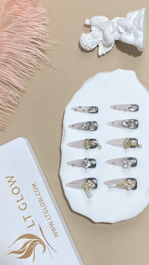 Showcasing LT-Glow's dedication to fine craftsmanship, these nails transition seamlessly from a gradient black, and are decorated with radiant pearls, glistening diamond embellishments, and dazzling crystal charms