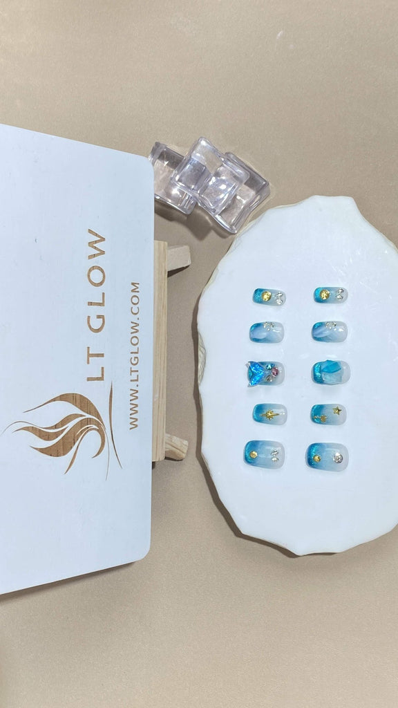 Revel in the soothing gradient of blue on these squoval fake nails, further accentuated with twinkling crystals and delicate charms. A perfect addition to your artificial nails collection