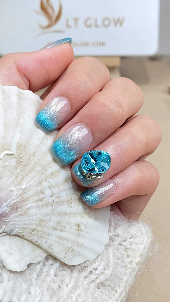 Gradient blue press on nails, embellished with sparkling diamonds and crystals, handcrafted into a refined squoval shape