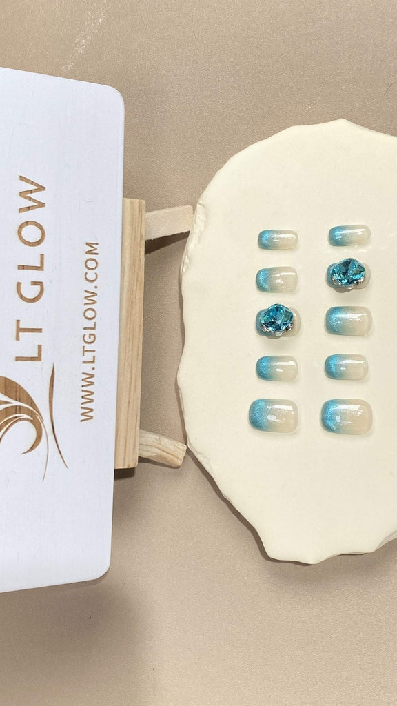 Acrylics nails design in a mesmerizing gradient blue, accentuated with premium diamonds and crystals for an artificial nails experience like no other