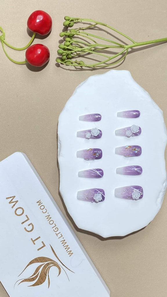 Coffin-styled fake nails from LTGlow, capturing the allure of gradient purple, complemented by radiant diamond accents, delicate roses, and pearls