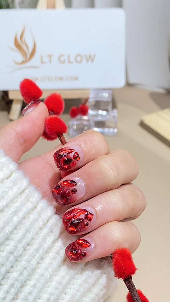 Handmade round press-on nails by LTGlow, featuring a striking gradient red design, enhanced with sparkling glitter and shimmering diamond accents