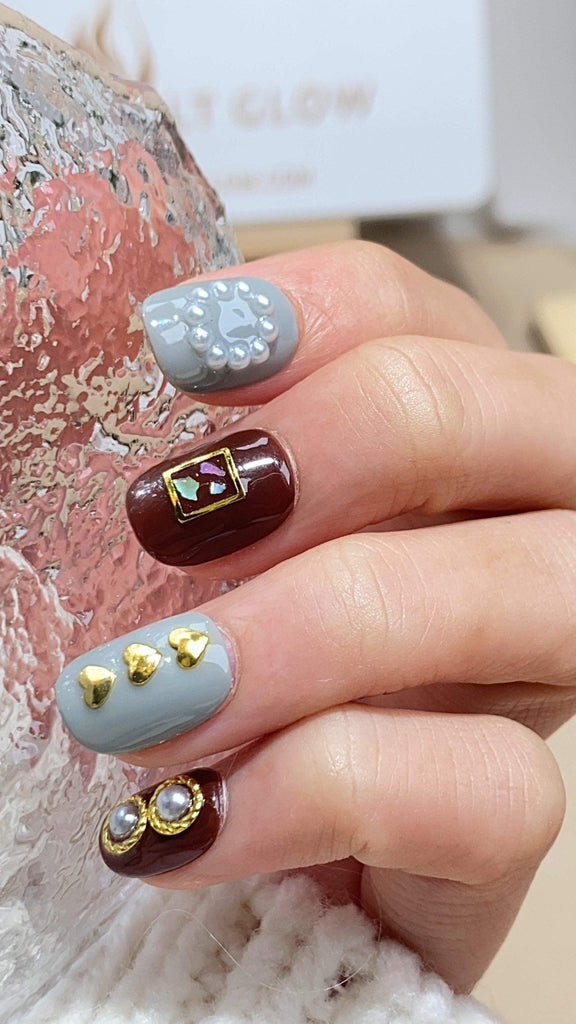 Handmade round press-on nails by LTGlow, featuring a nuanced blend of gray and brown adorned with glitter, pearls, and crystal embellishments