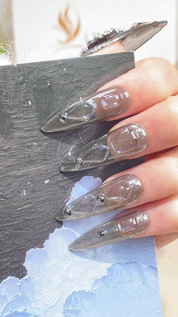 Handcrafted stiletto press-on nails by LTGlow, featuring a modern gray design adorned with shimmering glitter and diamond embellishments