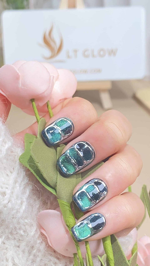 Elegant green squoval press-on nails showcasing intricate hand-painted designs, a testament to superior handcraft