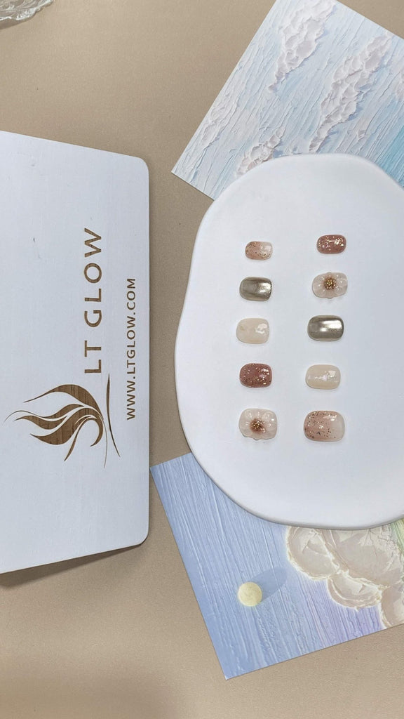 LT-Glow presents a masterpiece in nail art with its nude and gold flower design, punctuated by glistening glitter and lavish 3D charms. Each squoval nail reflects handcrafted precision and artistic flair