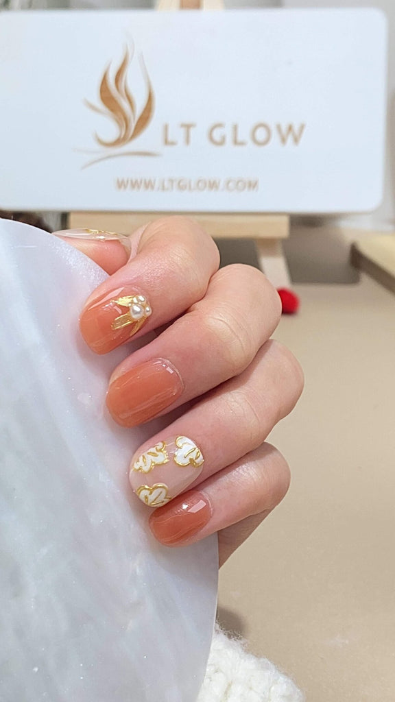 Exquisite squoval press-on nails by LT-Glow, artfully hand-painted in shades of nude and pink, embellished with a pearl flower for an elevated touch