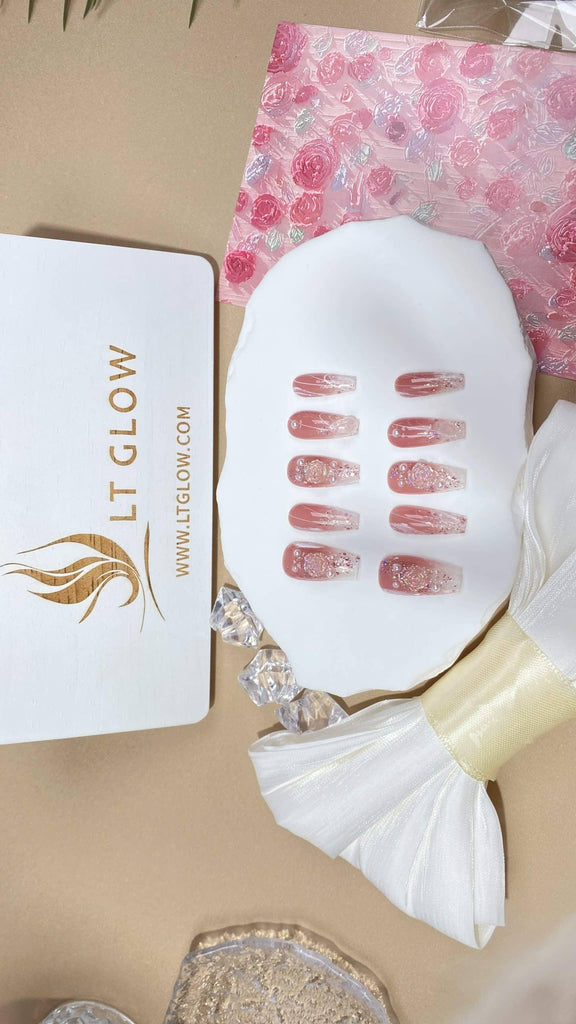 Coffin-styled fake nails by LTGlow, adorned with elegant pink, rose, glitter, and pearl details