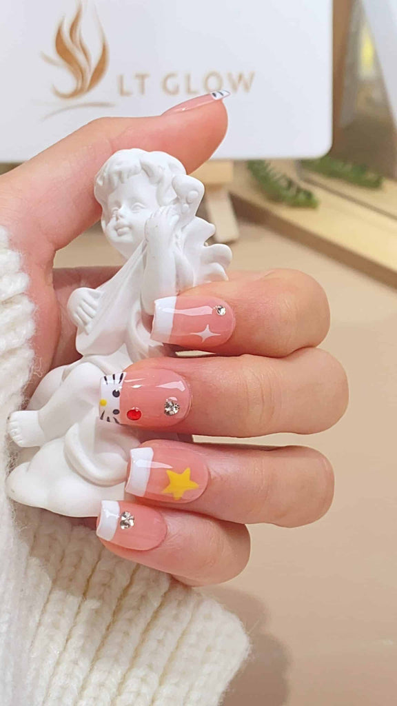 Handmade squoval press-on nails by LTGlow, featuring a harmonious blend of pink and white with diamond embellishments and a cat-inspired design