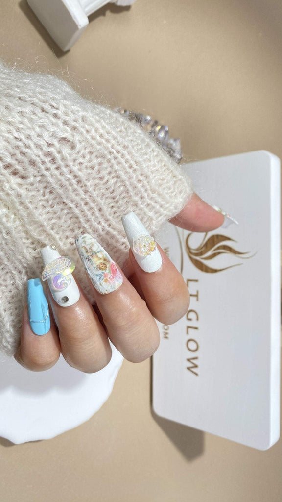 Handcrafted press-on nails by LTGlow in a coffin shape, featuring elegant swan designs in blue and white hues