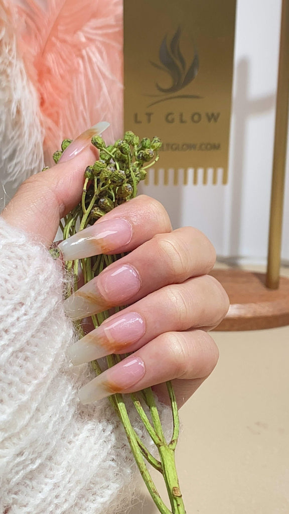 LT Glow's Chic White and Brown Long Coffin Nails, a testament to artisanal handcrafting