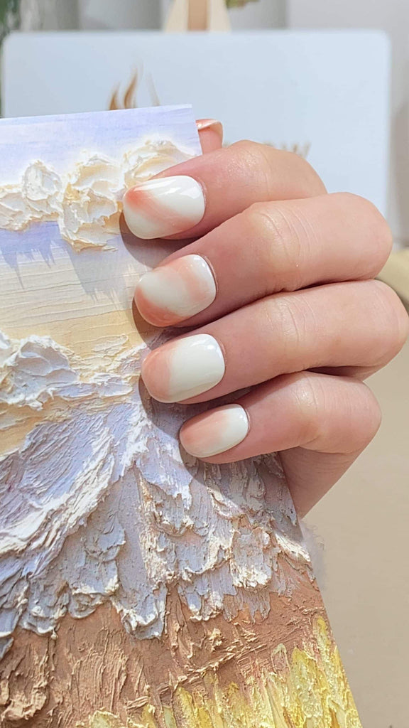 Chic round press-on nails by LT-Glow, showcasing a beautiful transition from pristine white to subtle nude gradient for a minimalist touch