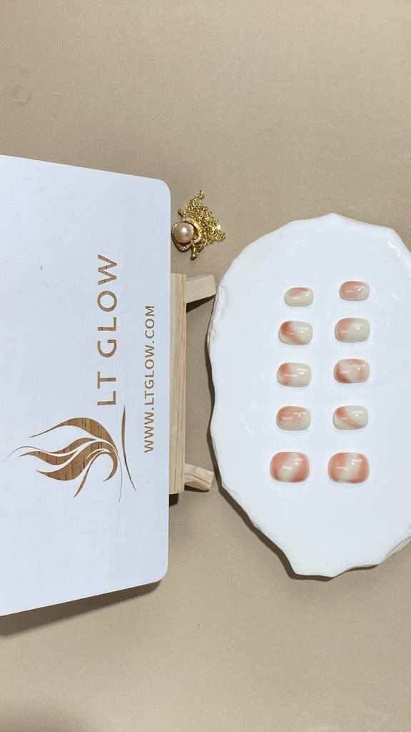 Handcrafted round fake nails from LT-Glow, displaying an exquisite gradient flow from a crisp white to a muted nude tone