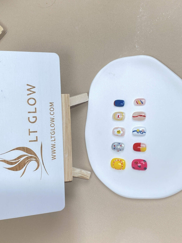 Round-styled fake nails from LTGlow, showcasing a vibrant mix of white and red, complemented by whimsical cartoon charms