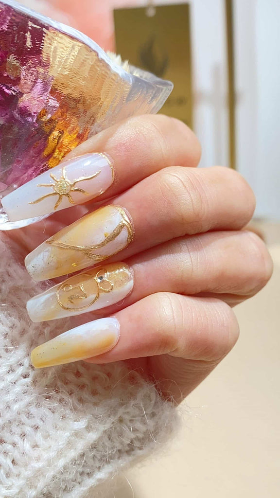 Embrace elegance with our white to yellow gradient coffin-shaped press-on nails, meticulously hand-painted and accented with lustrous pearls