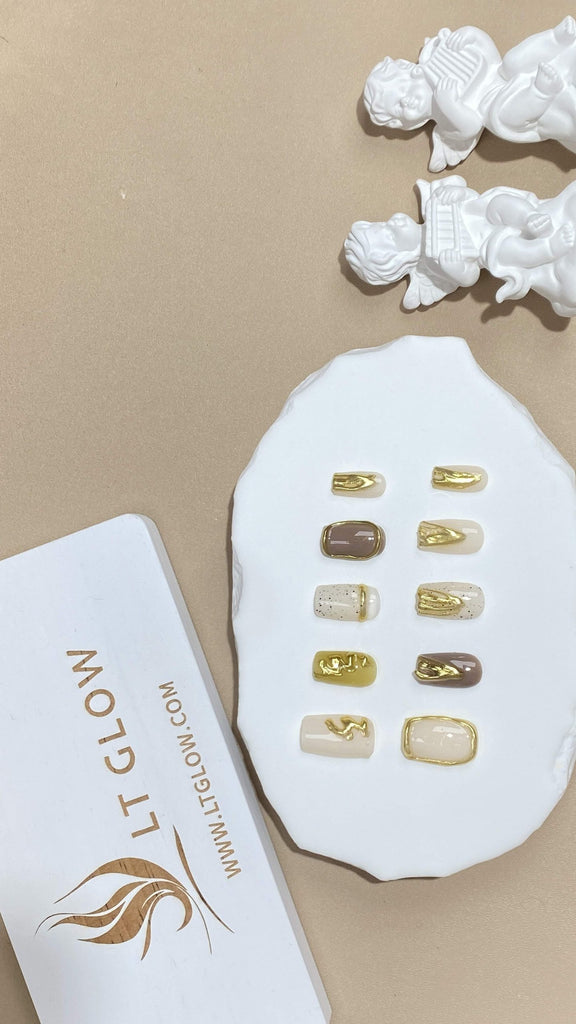 Square-styled fake nails from LT-Glow, featuring a canvas of white with sun-kissed yellow and earthy brown touches, adorned with innovative 3D designs for added depth