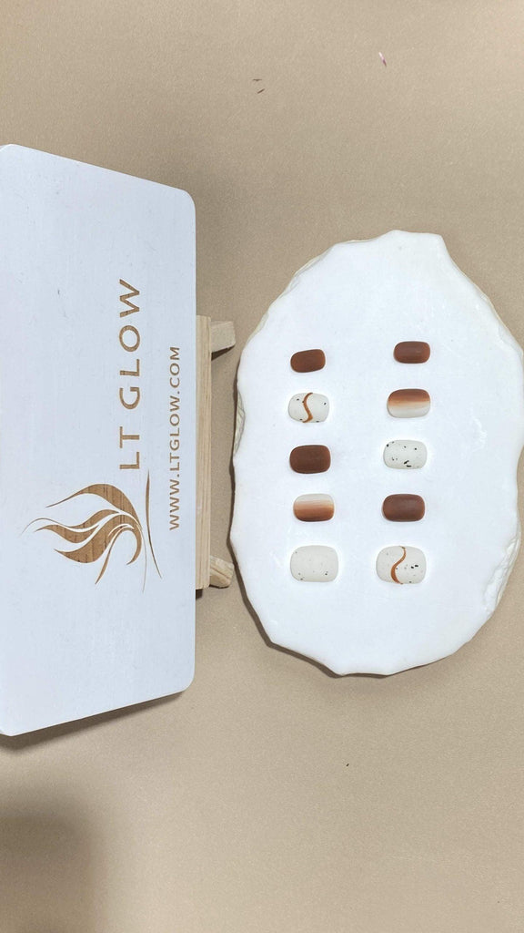 Round-styled fake nails from LTGlow, showcasing an artistic patchwork pattern blending white and brown shades