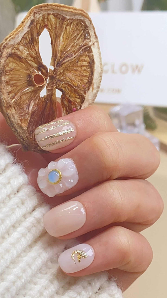 Handmade round press-on nails by LTGlow, featuring a crisp white hue adorned with delicate flower motifs, sparkling diamonds, and shimmering glitter for an elegant touch