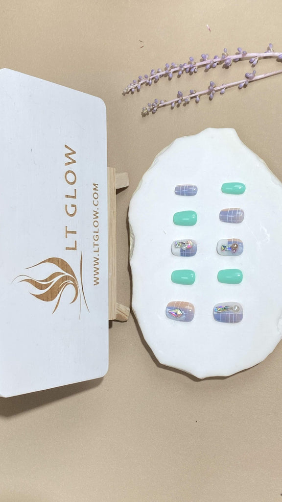 Squoval-styled fake nails from LT-Glow, presenting a harmonious blend of pristine white, lush green, and tranquil blue, adorned with elegant pearls and brilliant diamond accents