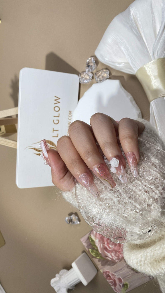 Elegant fake nails from LTGlow, showcasing gradient pink hues complemented by white rose motifs and shimmering pearl glitter