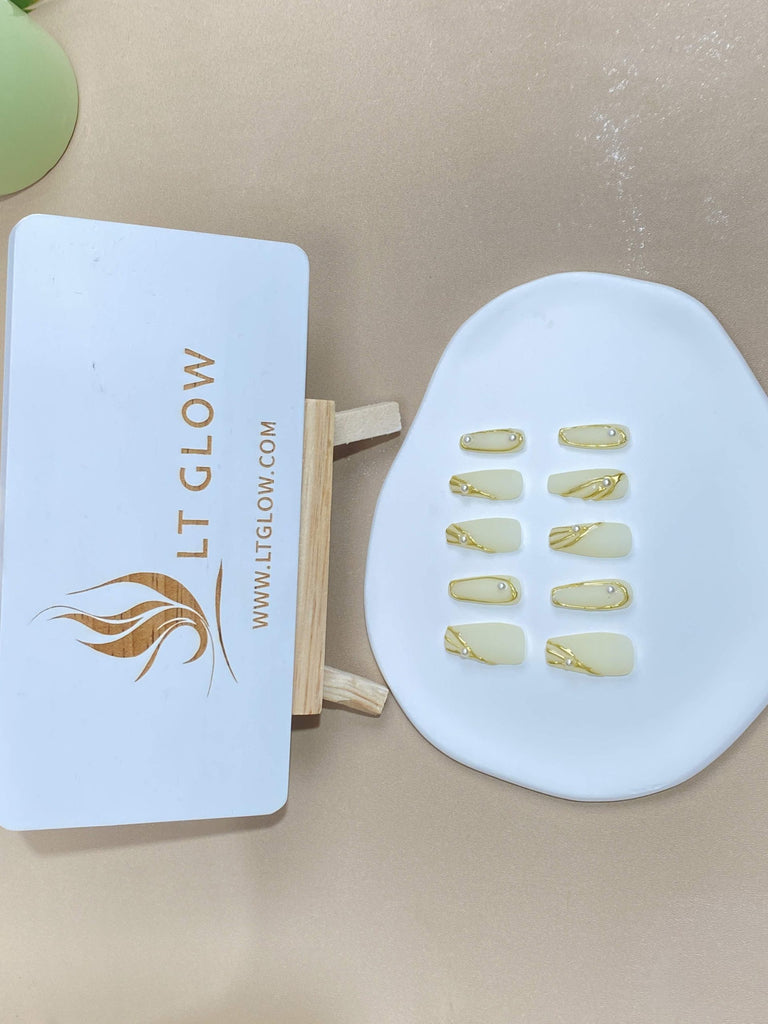 Coffin-styled fake nails from LTGlow, showcasing a chic combination of white and sunny yellow, adorned with radiant pearls for a touch of elegance