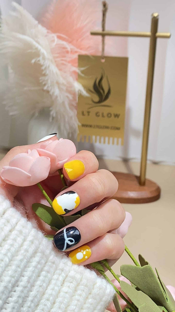Bright yellow round press-on nails by LT-Glow with striking black claw designs, meticulously handcrafted for perfection