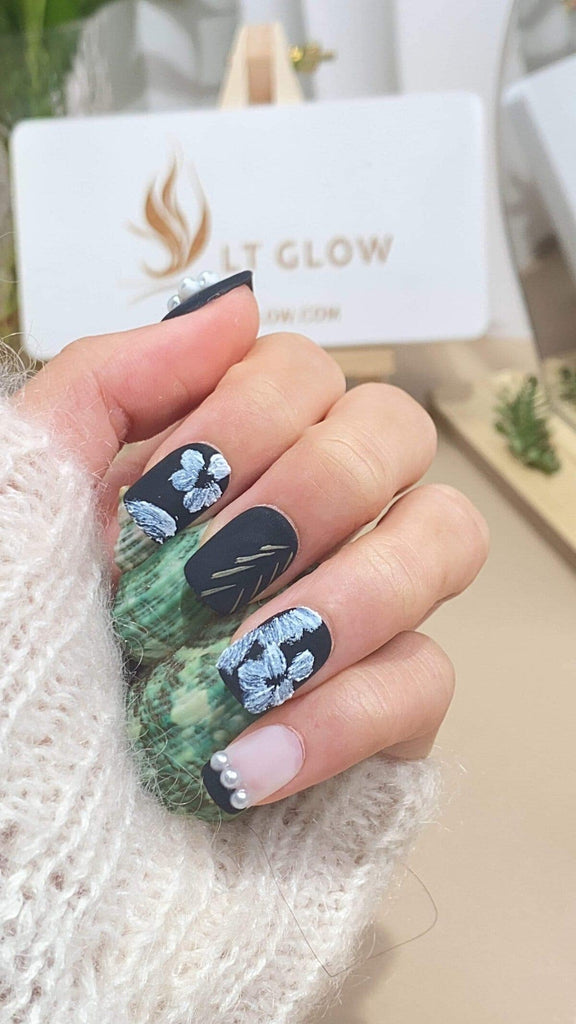 Exquisite squoval press-on nails by LT-Glow, hand-painted with a delicate white flower design on a blank canvas for a minimalist touch