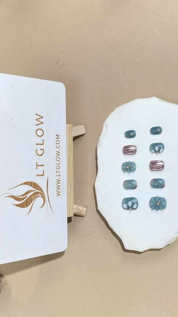 Showcasing LT-Glow's artisan craftsmanship, these blue squoval nails are meticulously hand-painted with delicate flowers, set off by gleaming silver undertones and centered pearls for a touch of sophistication