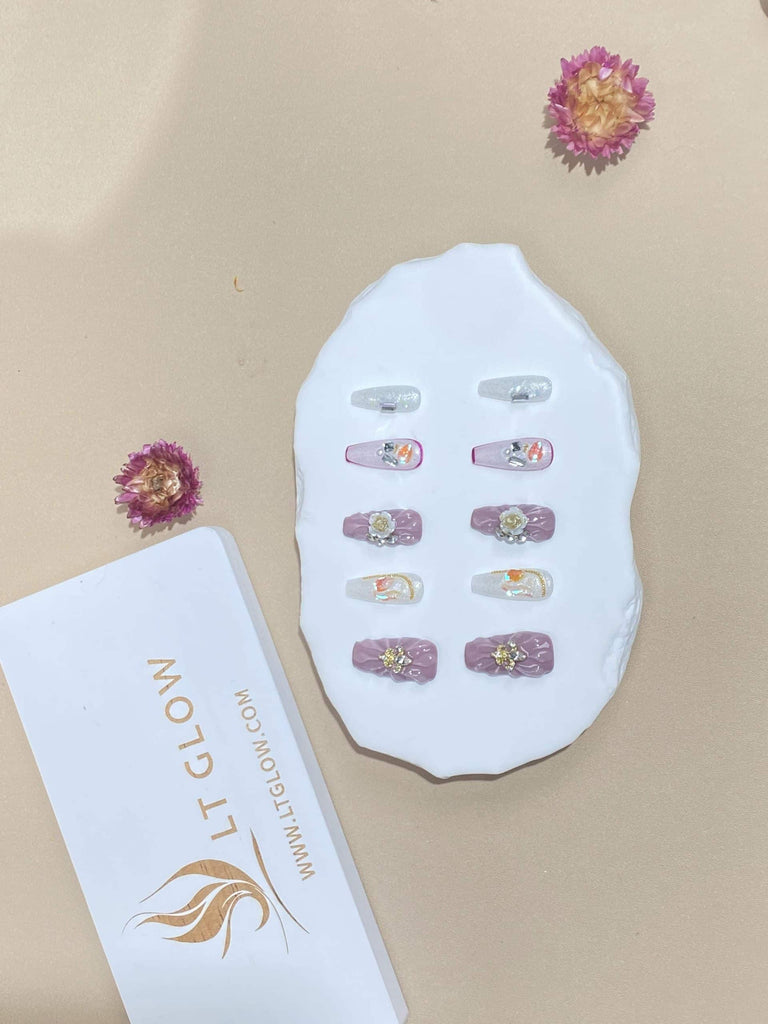 Handcrafted LT Glow Coffin Nails in Pristine White, Accented with Charms and Blooming Purple Flowers