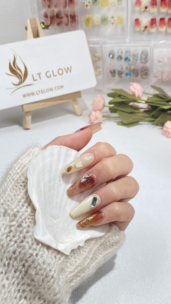 LT Glow's Radiant Coffin Nails in Brown and White, Adorned with Crystals and Glitter