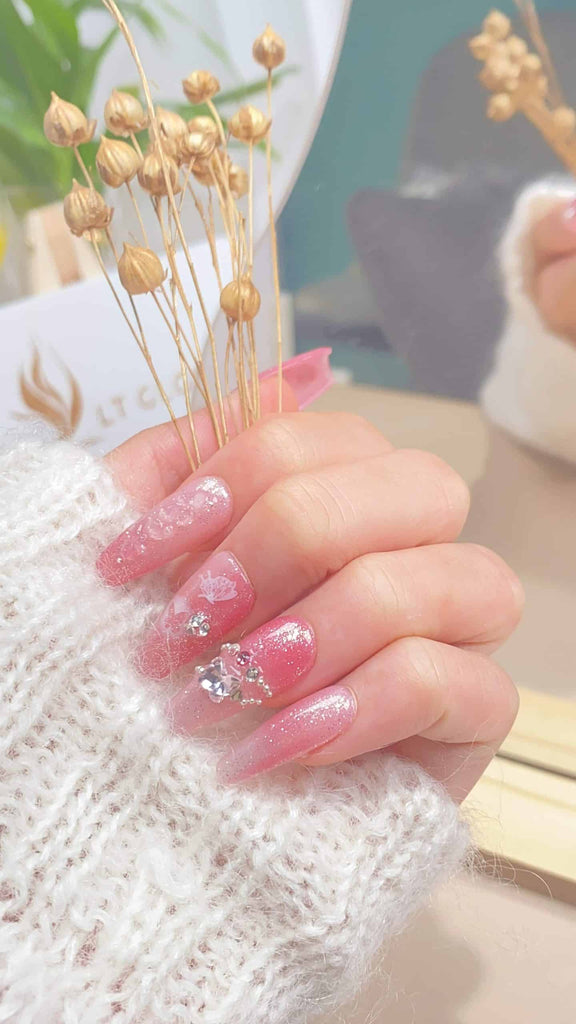 LT-Glow's exquisite coffin-shaped press-on nails featuring a gradient pink design, embellished with diamond charms for added elegance