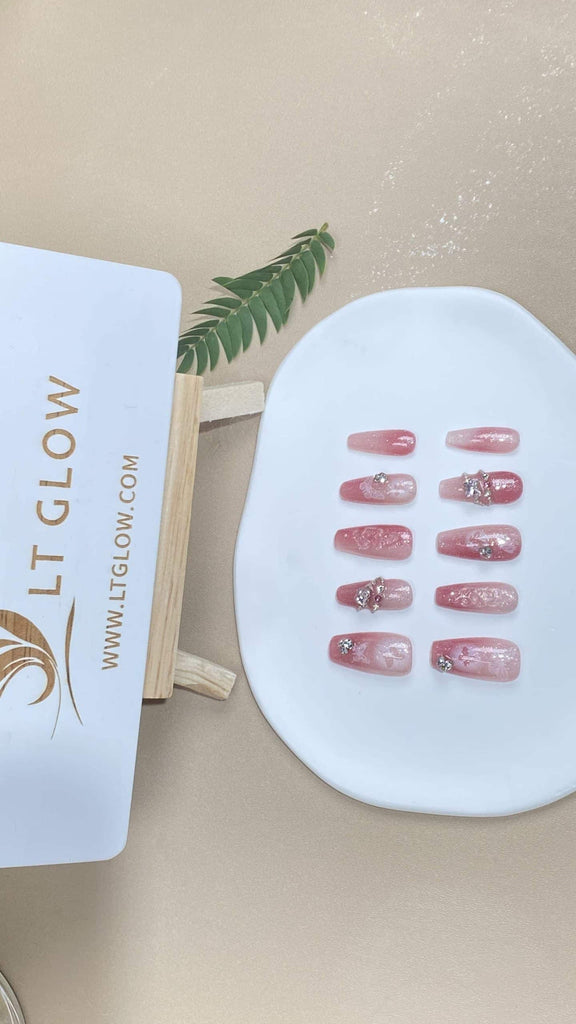 Handcrafted coffin-style artificial nails by LT-Glow, showcasing a captivating gradient pink hue, adorned with sparkling diamond charms