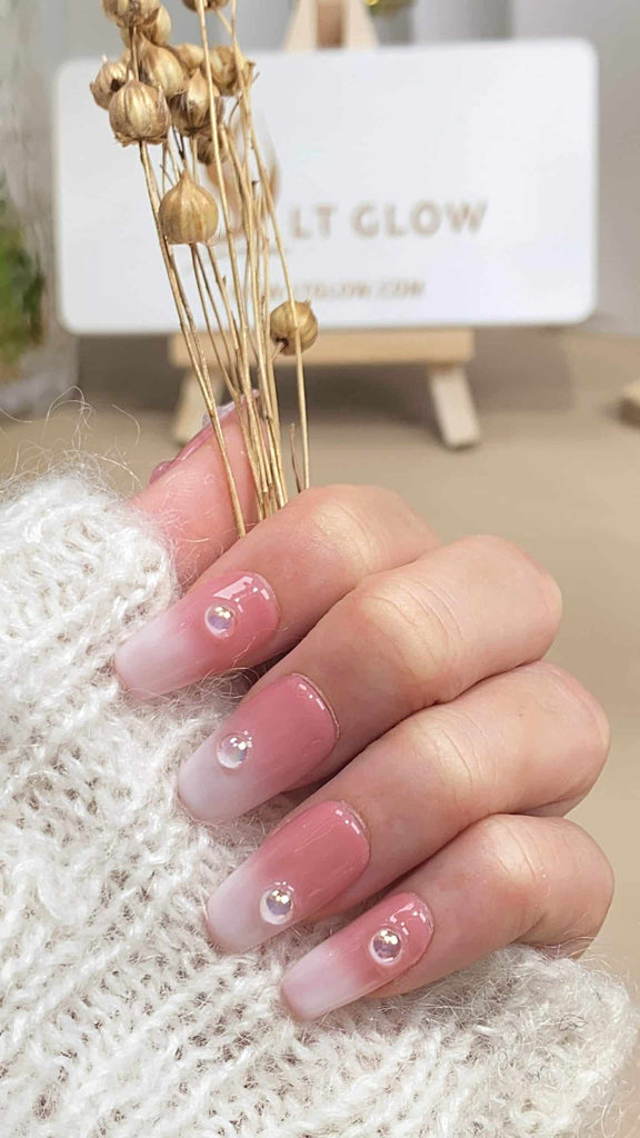 Handmade coffin-shaped press-on nails by LT-Glow, showcasing a beautiful gradient of pink hues, adorned with shimmering diamond embellishments