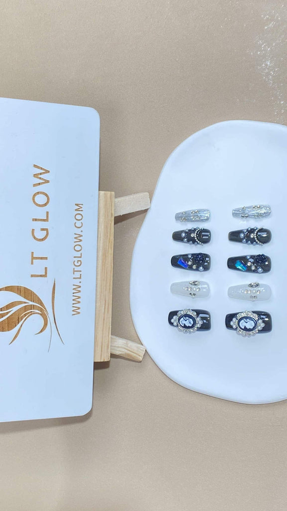 LTGlow's artisanal fake nails in a coffin design, showcasing a captivating blend of black beauty and white silver, embellished with pearl charms and crystals