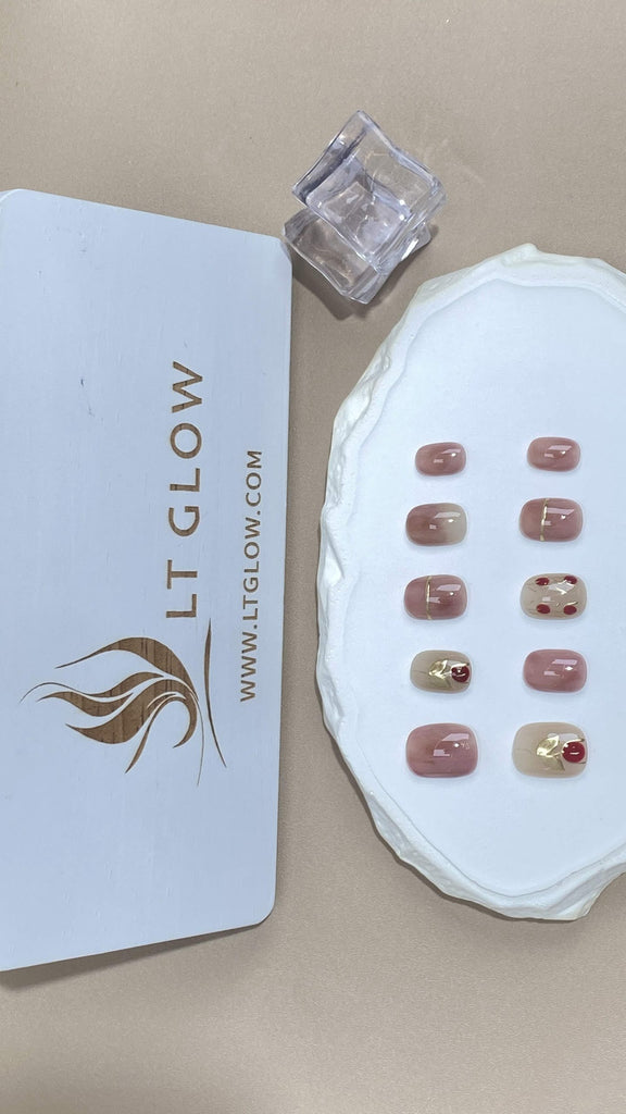 Round-styled fake nails from LT-Glow, showcasing a graceful blend of pink and nude hues, accentuated with beautifully detailed rose charms for a touch of elegance