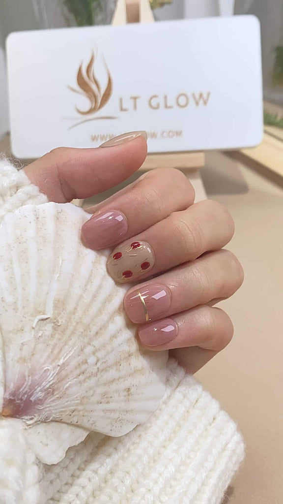 Exquisite round press-on nails by LT-Glow, crafted in delicate shades of pink and nude, adorned with rose motifs and complemented by charming embellishments