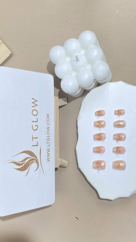 Handcrafted coffin fake nails from LT-Glow, displaying a vibrant gradient of pink to yellow, enhanced with sparkling crystal details and shimmering glitter