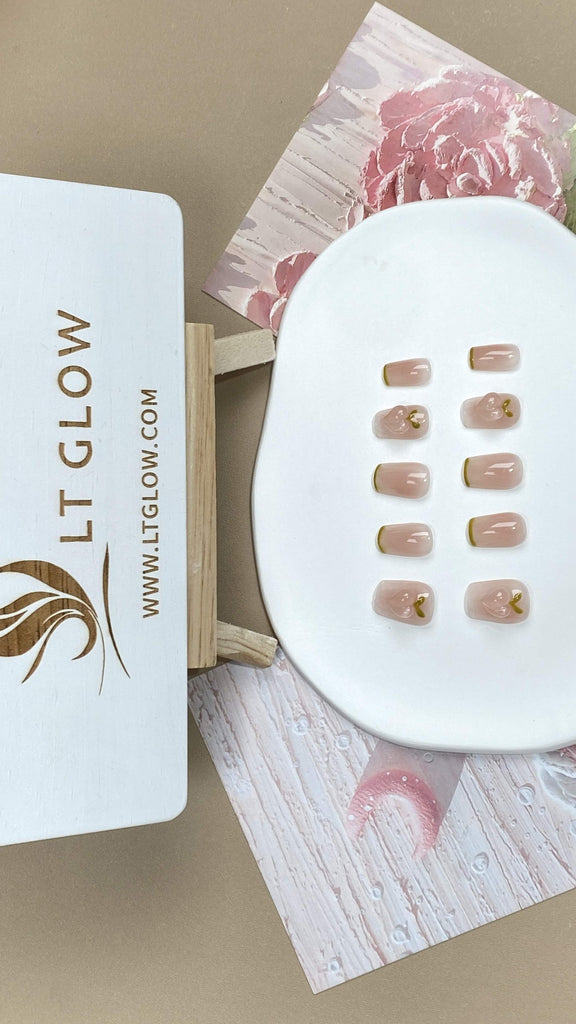 Squoval-styled fake nails from LT-Glow, showcasing a harmonious blend of pink and yellow, adorned with sparkling diamonds and subtle peach undertones