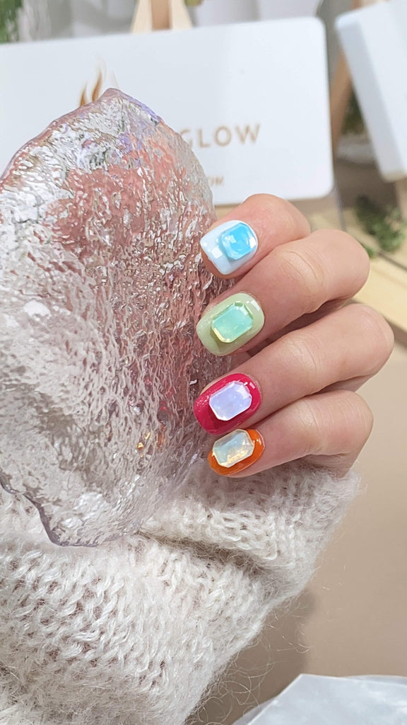 Elegant squoval press-on nails by LT-Glow, beautifully transitioning through a spectrum of colors from purple to orange, adorned with sparkling crystal accents