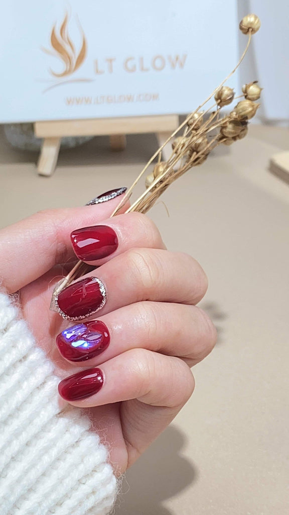 Handmade round press-on nails by LTGlow, featuring a bold red design adorned with sparkling glitter, charming accents, and lustrous pearls