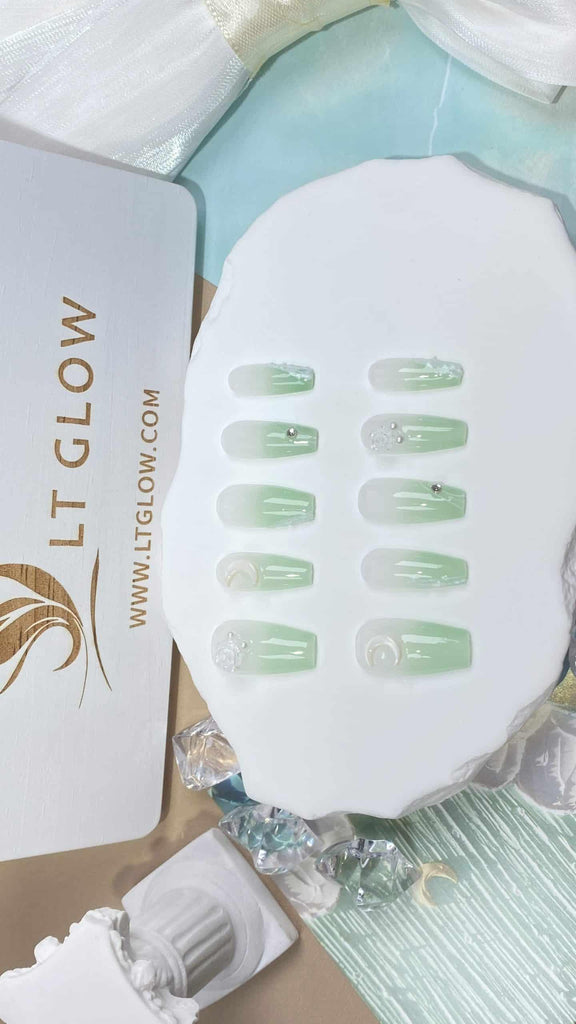 LTGlow's crafted fake nails in a coffin design, adorned with gradient green shades and detailed with rose, pearl, and moon elements