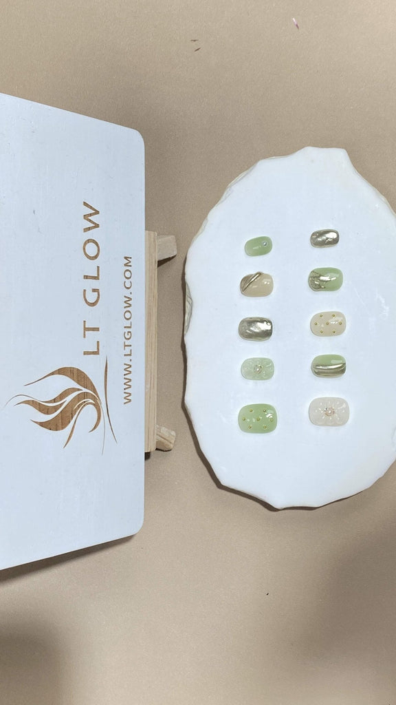 Showcasing LT-Glow's artisanal touch, these squoval nails offer a luxe white palette, embellished with glimmering gold hues, lustrous pearls, and stunning 3D charms. Hand-painted details attest to their premium quality and design